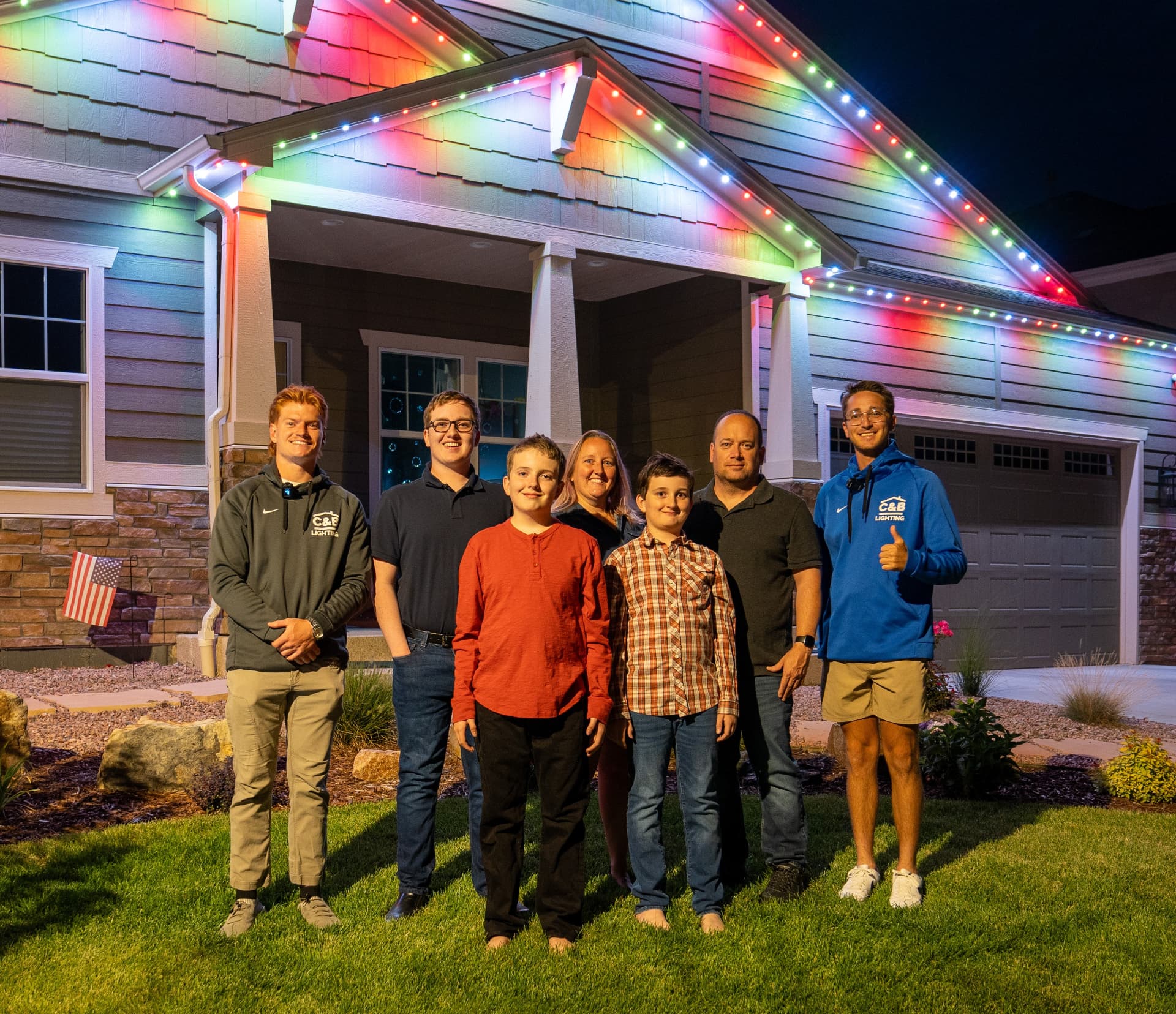 C&B Christmas Lights customers in front of their beautifully lit home